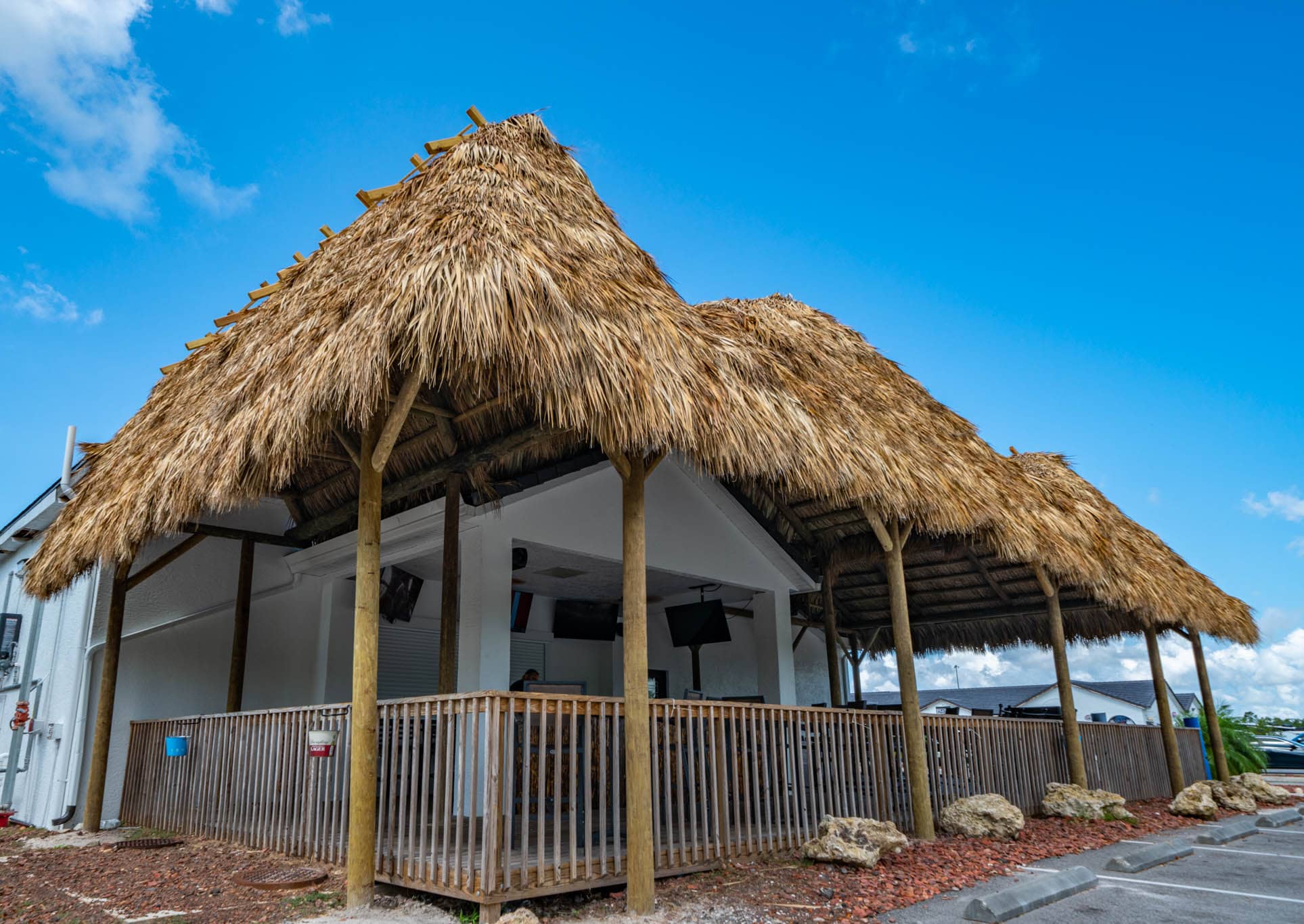 Large tiki covering a seating area for a restaurant